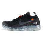 Air VaporMax co-branded Part 2 Black White Orange - Full Lateral Profile View on White Background Showing Black Fine-Knit Flyknit Upper Silver Large Swoosh with Black Edge Stitching Orange Industrial Zip Tie with Transparent Plastic Hang Tag Black Rope Laces White Woven Tongue Label with Orange Swoosh and Frosted Ice VaporMax Air Unit