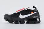 Air VaporMax co-branded The Ten Black White Red - Heel Counter Close Up on White Background Showing Grey Woven Collar Band at Collar Top Black Woven Heel Pull Tab with Orange Rectangular Accent VAPORMAX Text on Heel Counter White AIR Quotation-Mark Text at Heel Midsole Junction and Full Black VaporMax Air Unit at Heel