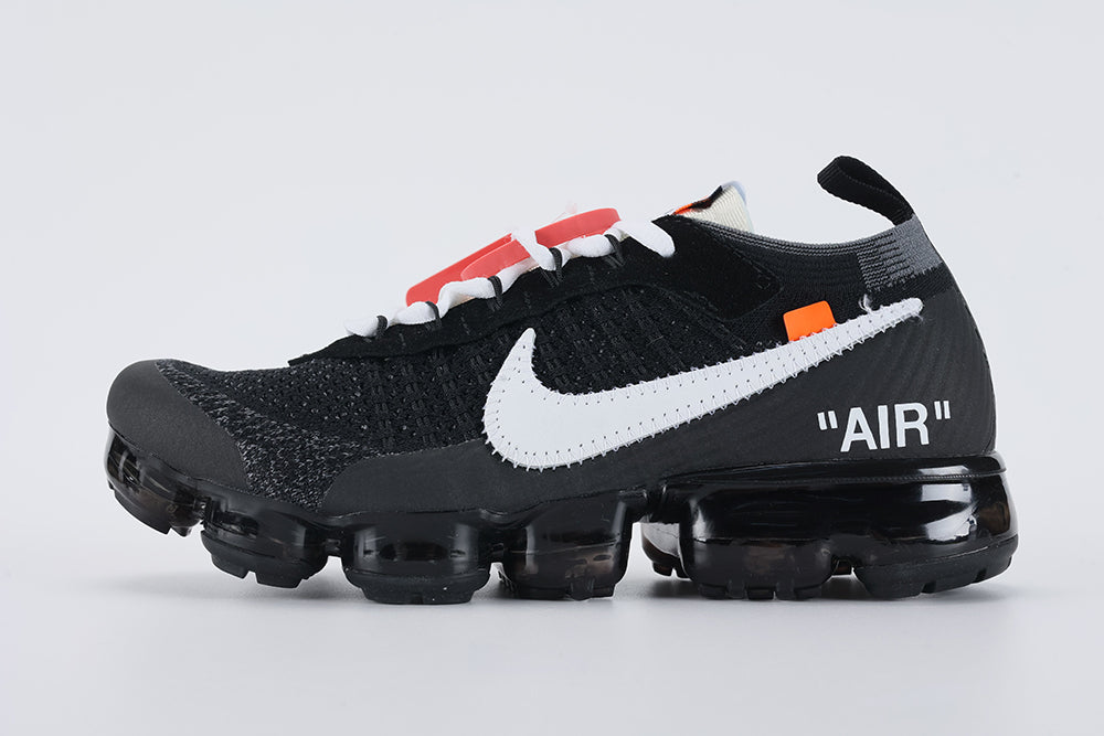 Air VaporMax co-branded The Ten Black White Red - Heel Counter Close Up on White Background Showing Grey Woven Collar Band at Collar Top Black Woven Heel Pull Tab with Orange Rectangular Accent VAPORMAX Text on Heel Counter White AIR Quotation-Mark Text at Heel Midsole Junction and Full Black VaporMax Air Unit at Heel